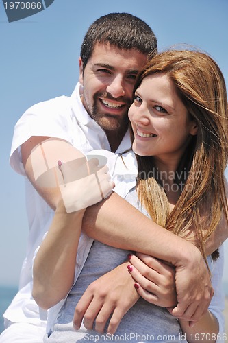 Image of happy young couple have fun on beach