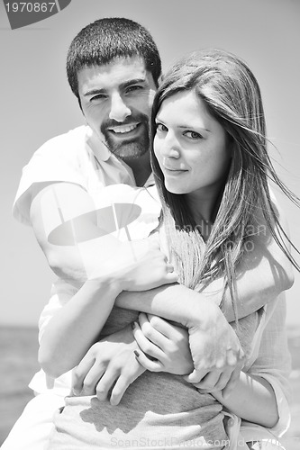 Image of happy young couple have fun on beach