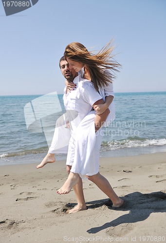 Image of happy young couple have fun on beach