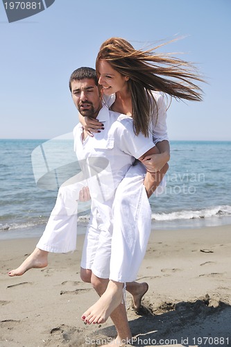 Image of happy young couple have fun on beach