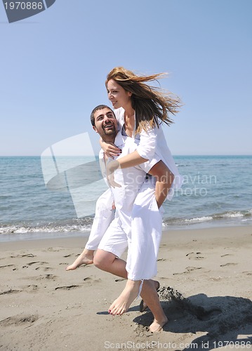 Image of happy young couple have fun on beach