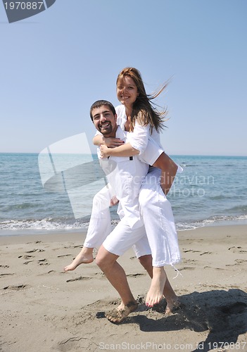 Image of happy young couple have fun on beach
