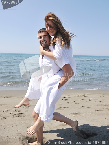 Image of happy young couple have fun on beach