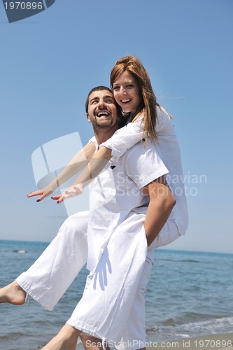 Image of happy young couple have fun on beach