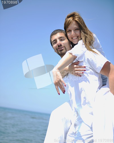 Image of happy young couple have fun on beach