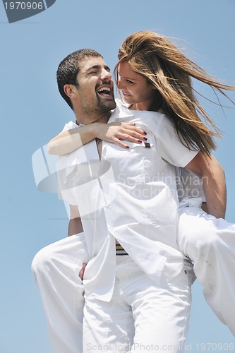 Image of happy young couple have fun on beach