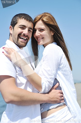 Image of happy young couple have fun on beach