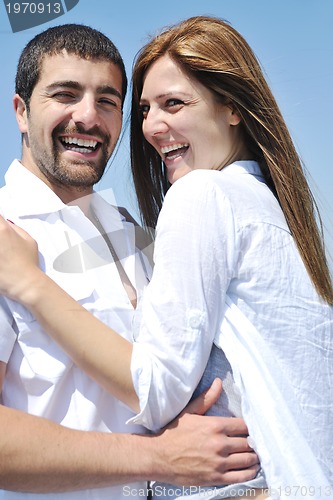 Image of happy young couple have fun on beach