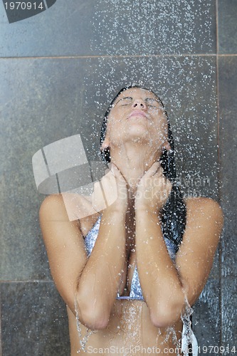 Image of sexy young woman enjoing bath under water shower