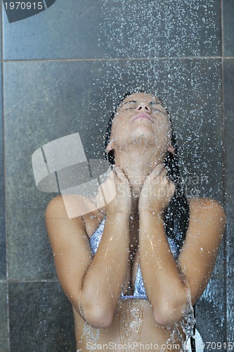 Image of sexy young woman enjoing bath under water shower