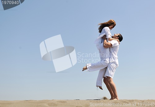 Image of happy young couple have fun on beach