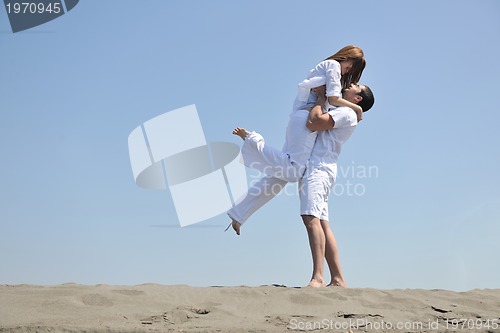 Image of happy young couple have fun on beach