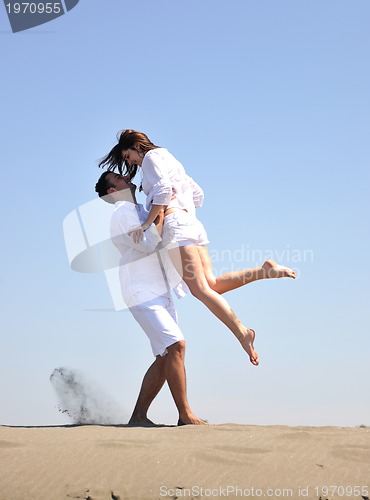 Image of happy young couple have fun on beach