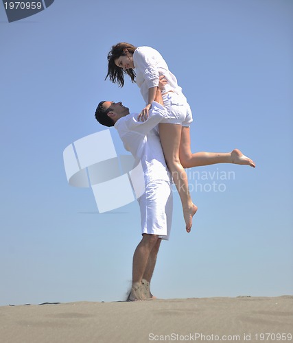 Image of happy young couple have fun on beach