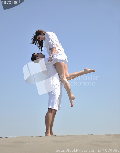 Image of happy young couple have fun on beach
