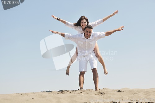 Image of happy young couple have fun on beach