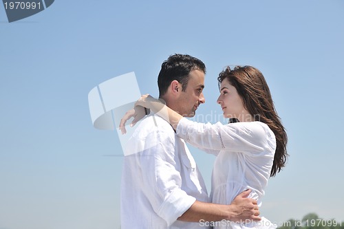 Image of happy young couple have fun on beach