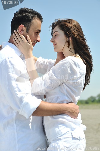 Image of happy young couple have fun on beach