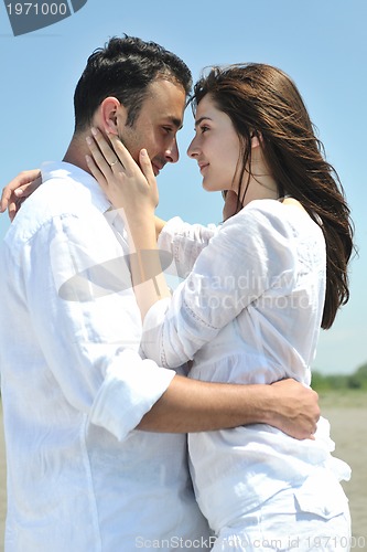 Image of happy young couple have fun on beach