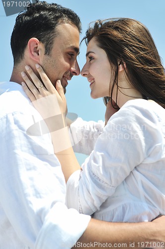 Image of happy young couple have fun on beach