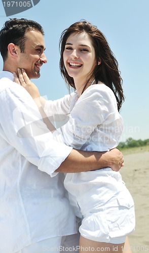 Image of happy young couple have fun on beach