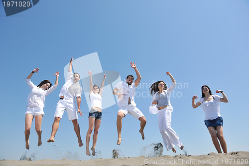 Image of happy people group have fun and running on beach