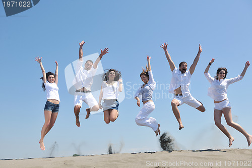 Image of happy people group have fun and running on beach
