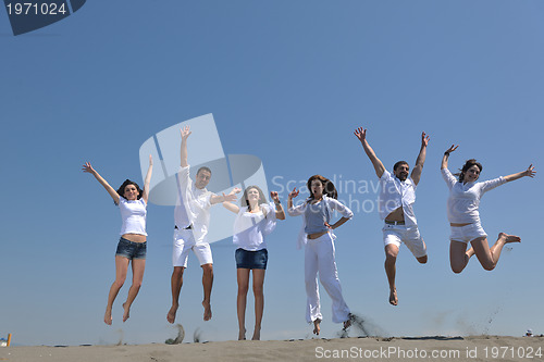 Image of happy people group have fun and running on beach