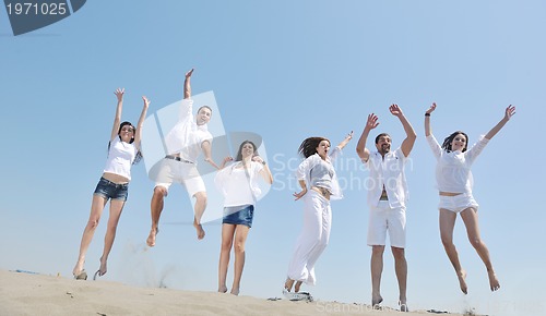 Image of Group of happy young people in have fun at beach
