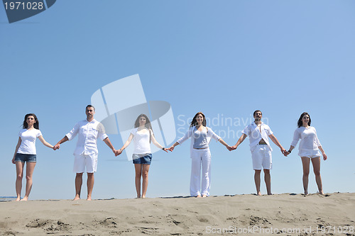 Image of happy people group have fun and running on beach