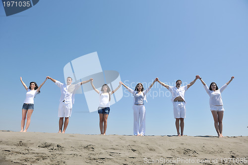 Image of happy people group have fun and running on beach