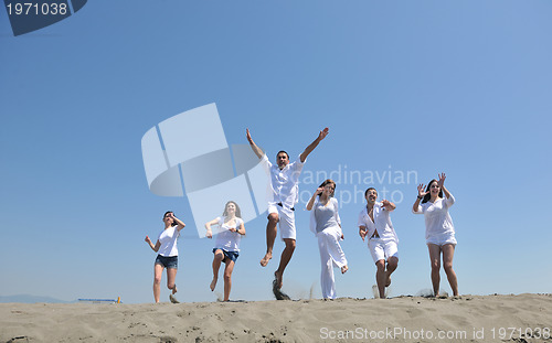 Image of happy people group have fun and running on beach
