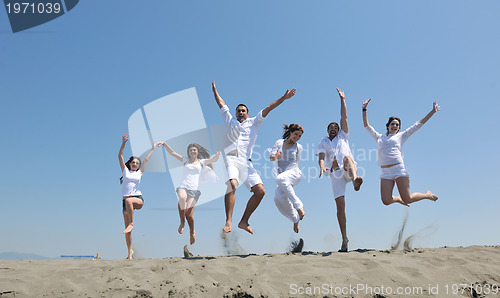 Image of happy people group have fun and running on beach