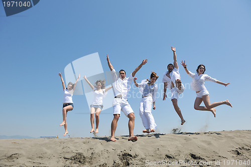 Image of happy people group have fun and running on beach