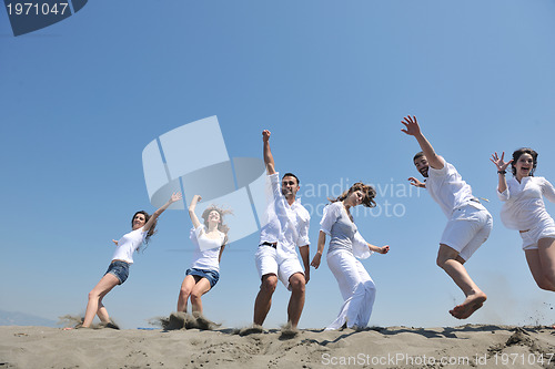 Image of happy people group have fun and running on beach