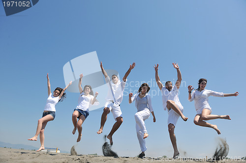 Image of happy people group have fun and running on beach