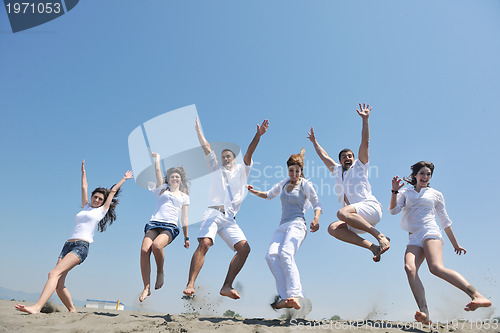 Image of happy people group have fun and running on beach