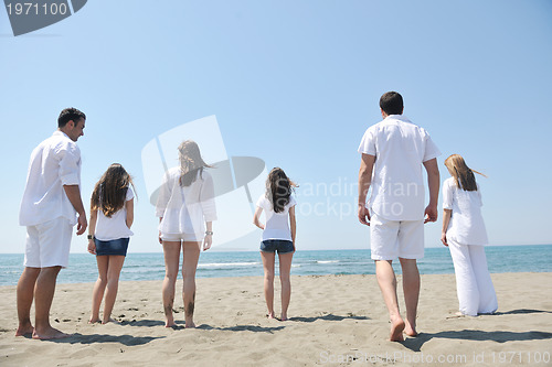 Image of happy people group have fun and running on beach