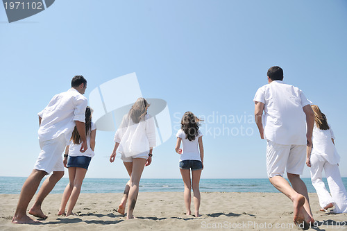 Image of happy people group have fun and running on beach