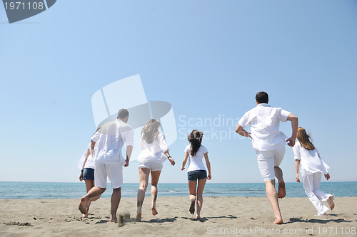 Image of happy people group have fun and running on beach