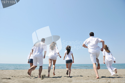 Image of happy people group have fun and running on beach