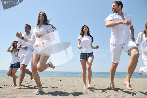 Image of happy people group have fun and running on beach