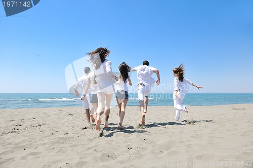 Image of happy young  people group have fun on beach