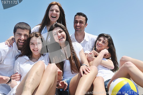 Image of Group of happy young people in have fun at beach