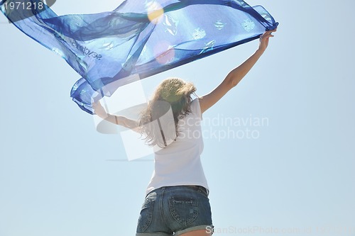 Image of beautiful young woman on beach with scarf