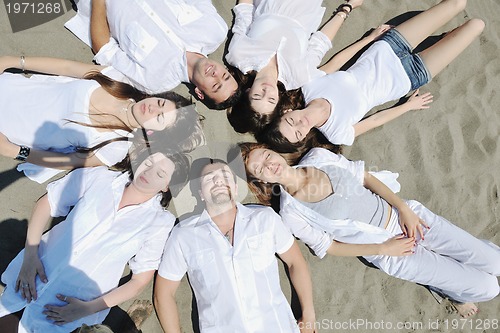 Image of Group of happy young people in have fun at beach