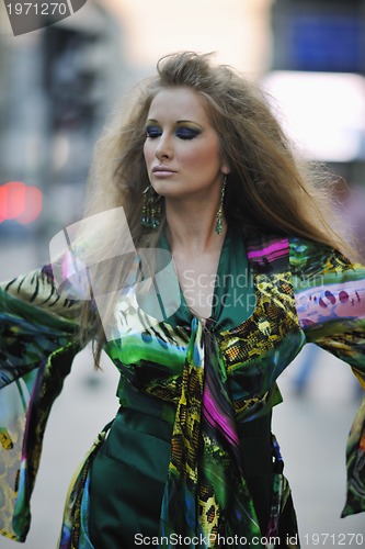 Image of elegant woman on city street at night