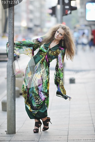 Image of elegant woman on city street at night