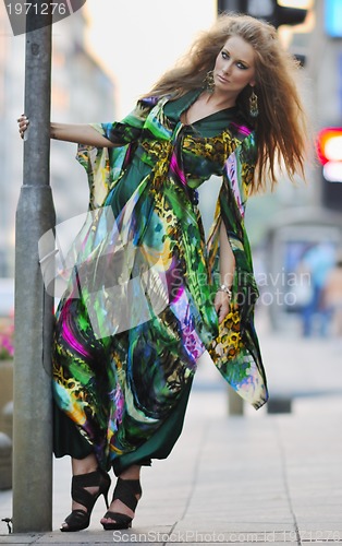 Image of elegant woman on city street at night