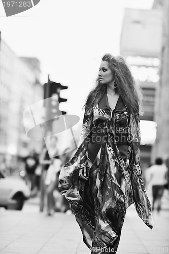 Image of elegant woman on city street at night